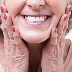 A smiling woman enjoying her dentures