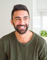 man smiling and sitting