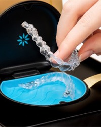 Invisalign trays being placed in a protective case
