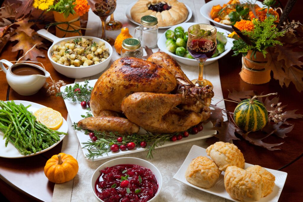 Turkey and thanksgiving side dishes on a dressed table